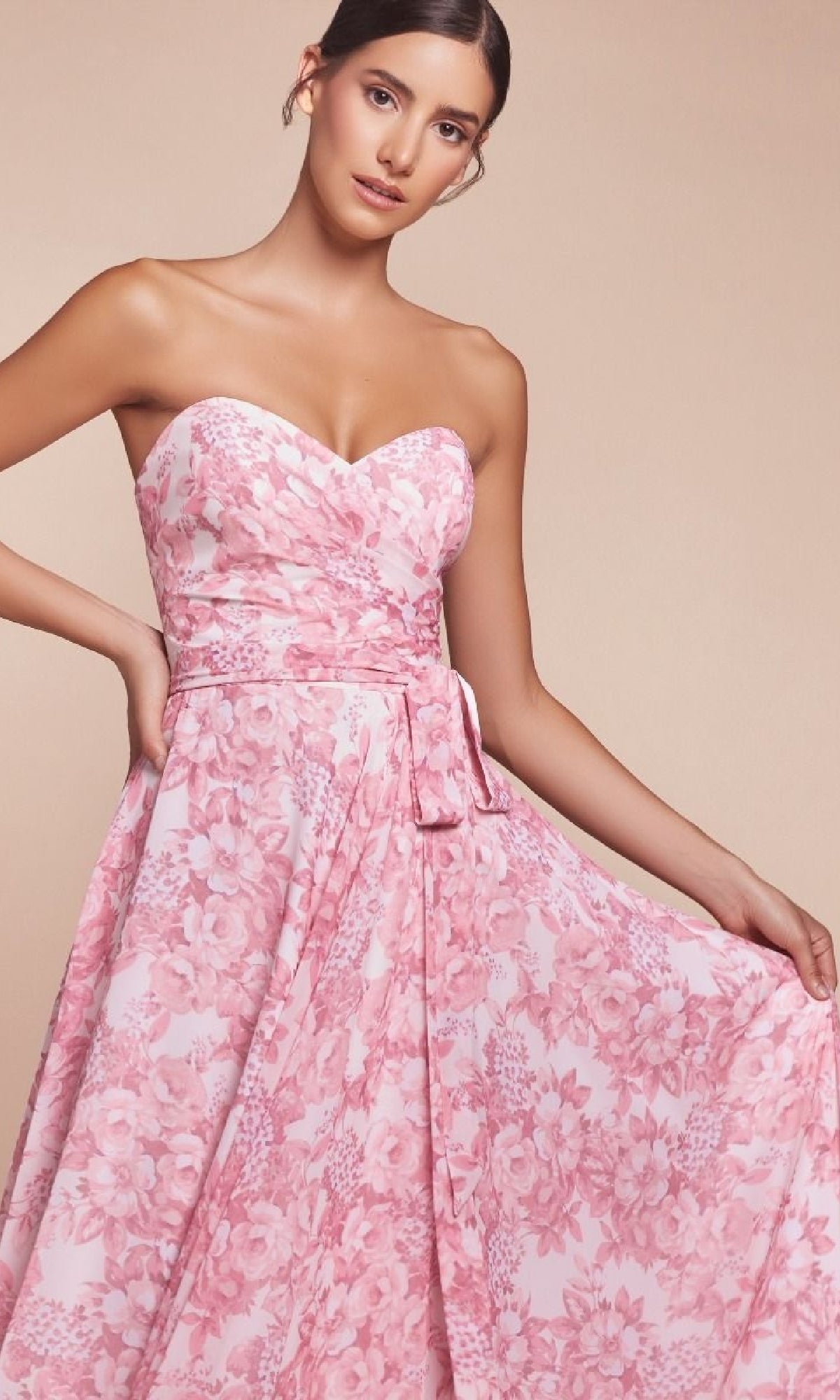 A woman poses against a neutral background wearing the CL7443 Strapless Long Print Prom Dress, featuring a sweetheart neckline and pink floral pattern.